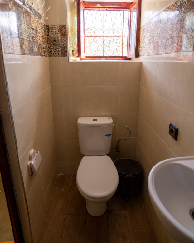 Chambre simple avec douche et toilettes.